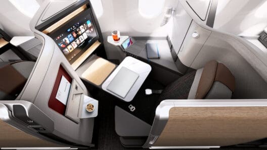 an airplane with a laptop and a tv