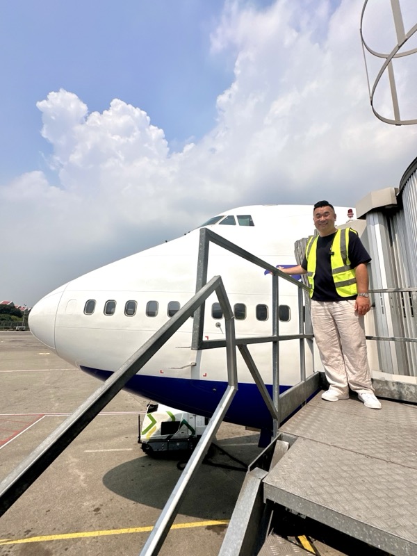 a man standing on a stairway next to a plane