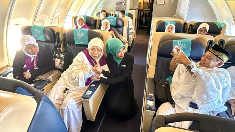 a group of people sitting on chairs in a plane