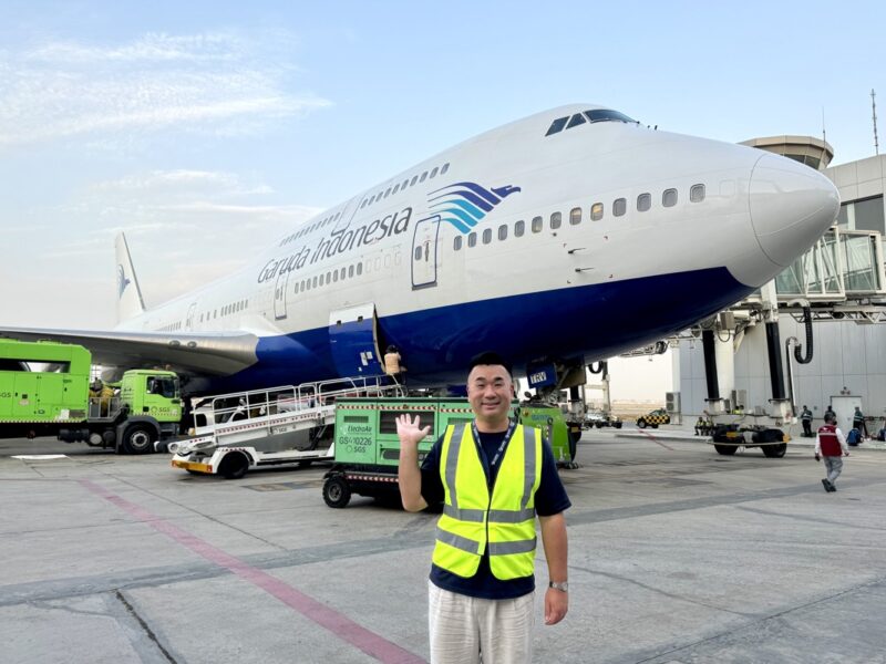 a man standing in front of a large airplane