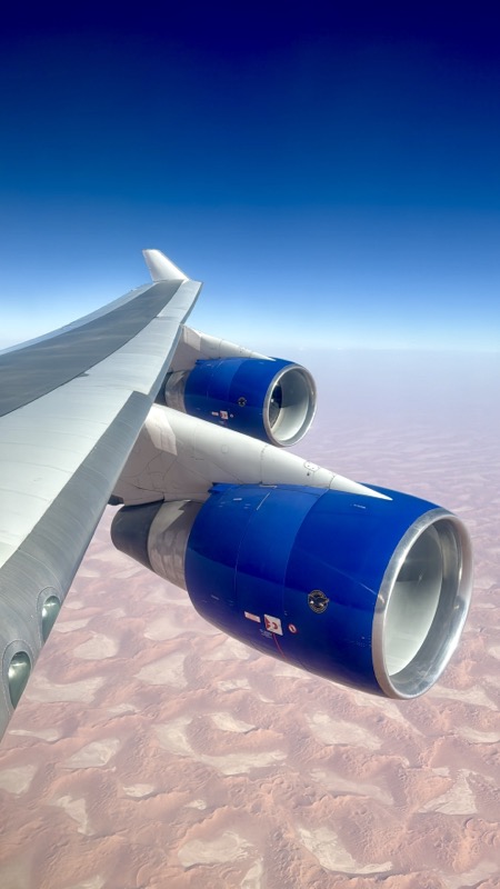 a plane wing with blue engines