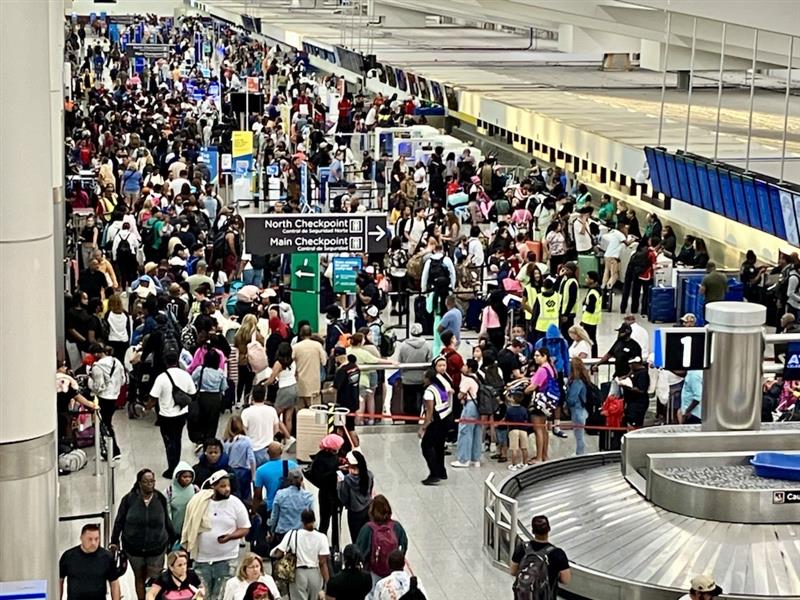 a large crowd of people in an airport