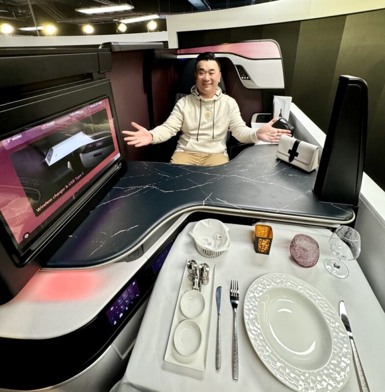 a man sitting at a table with a television