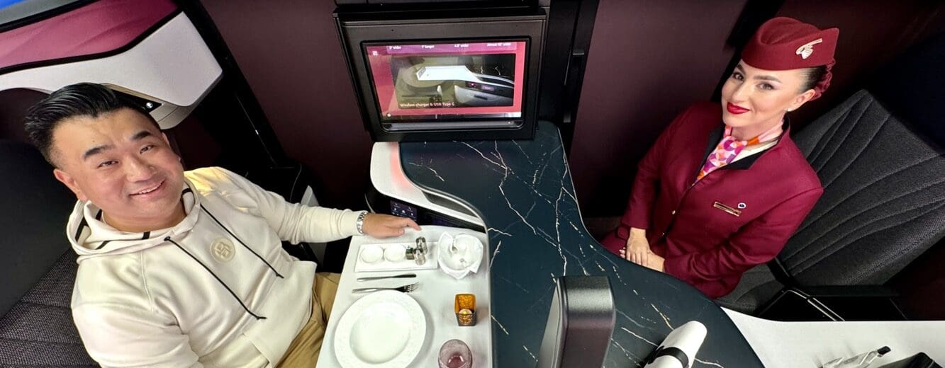 a man and woman sitting at a table in a cabin