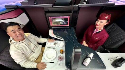 a man and woman sitting at a table in a cabin