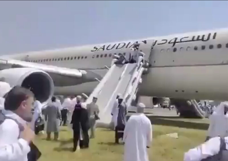 a group of people standing around an airplane