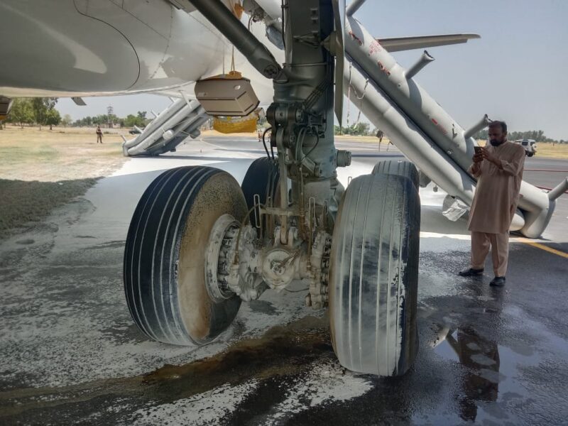 a man standing next to a plane