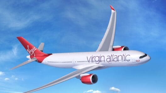 a white and red airplane flying in the sky