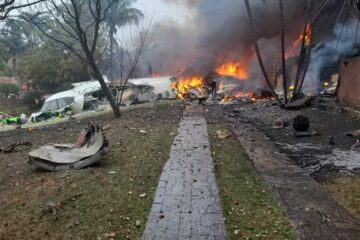 a building on fire with debris and smoke