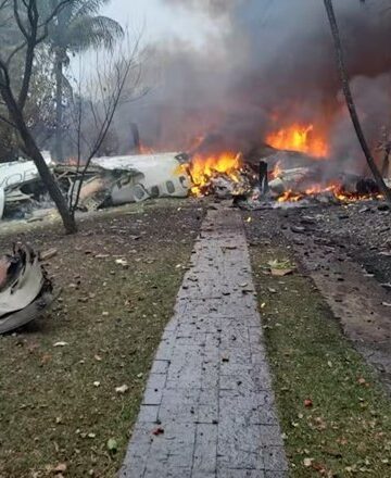 a building on fire with debris and smoke