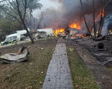 a building on fire with debris and smoke