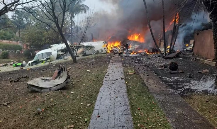 a building on fire with debris and smoke