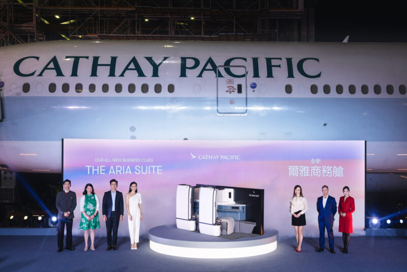 a group of people standing in front of a plane