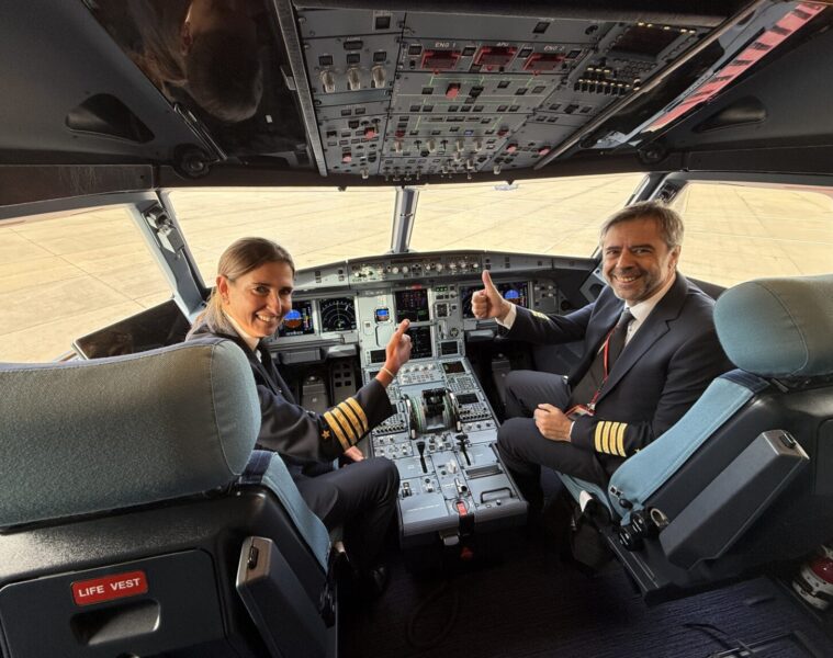 a man and woman sitting in a cockpit of an airplane