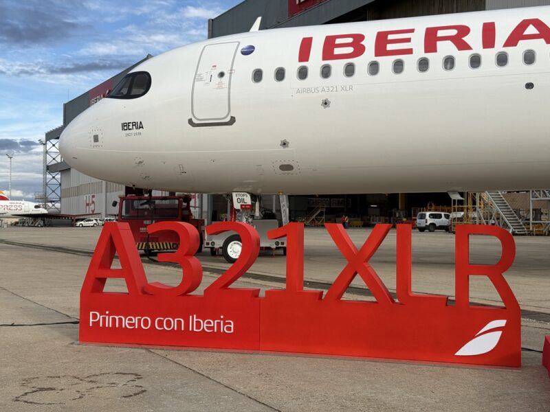 a large white airplane with red sign