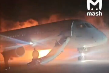 a plane with a man standing on the ground