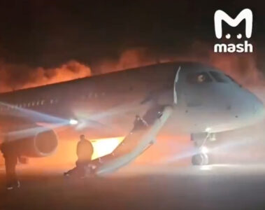 a plane with a man standing on the ground