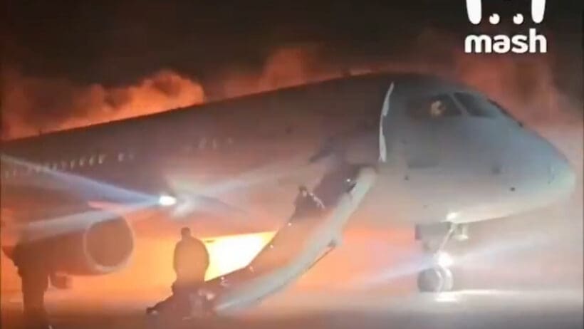 a plane with a man standing on the ground