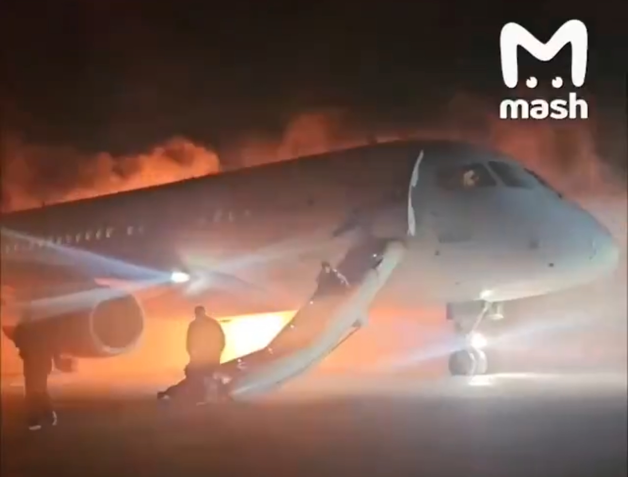 a plane with a man standing on the ground