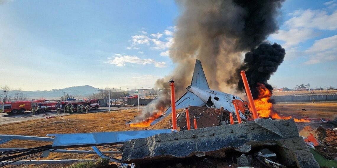 a plane on fire with black smoke