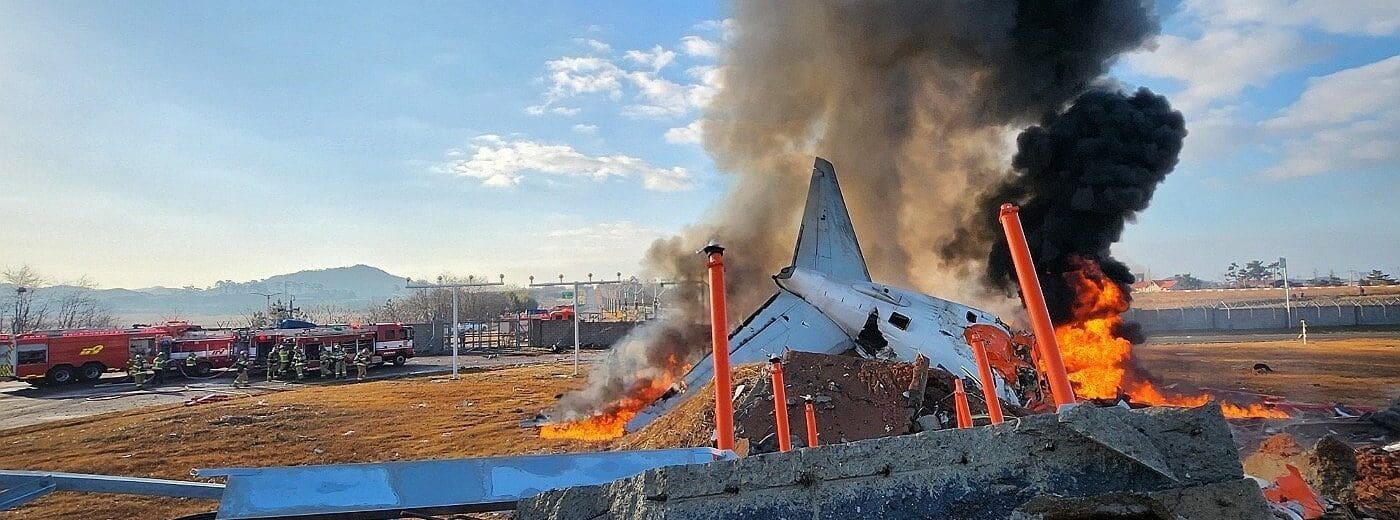 a plane on fire with black smoke