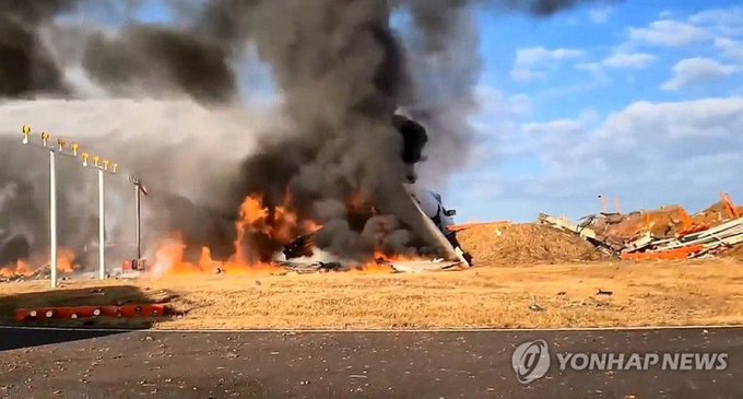 a plane on fire with black smoke