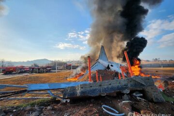 a plane on fire with black smoke