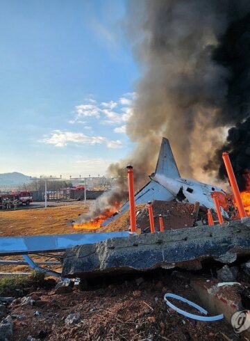 a plane on fire with black smoke