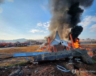 a plane on fire with black smoke