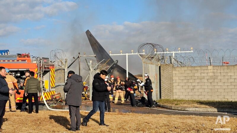 a group of people standing near a plane