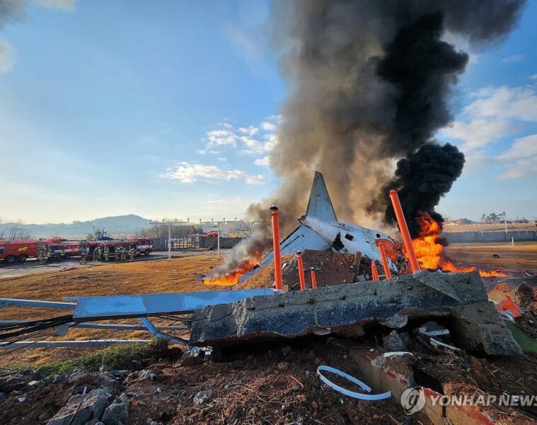 a plane on fire with black smoke