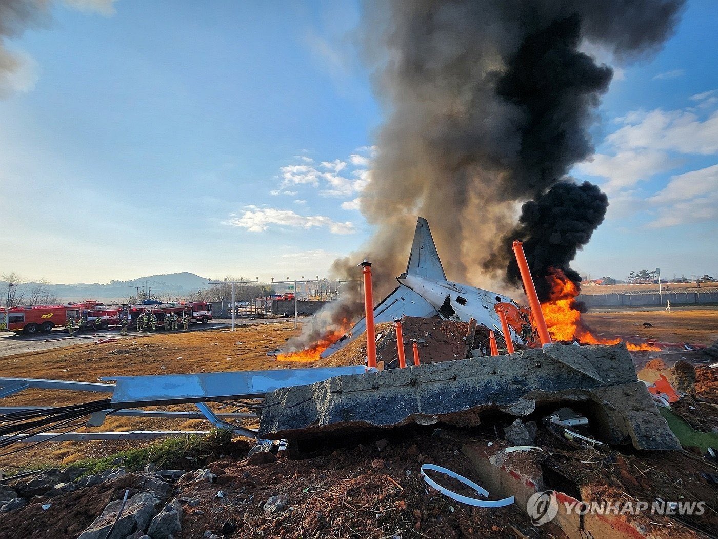 a plane on fire with black smoke