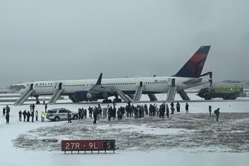 a group of people standing around an airplane