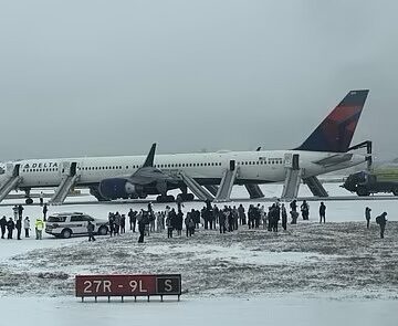 a group of people standing around an airplane