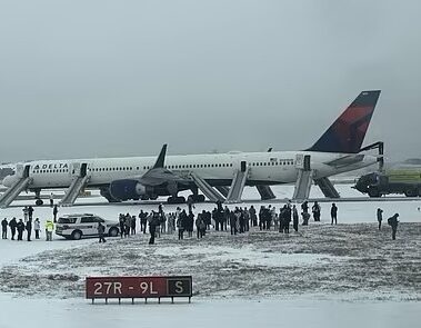 a group of people standing around an airplane