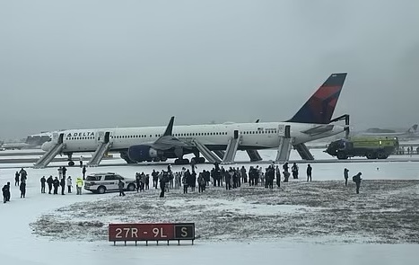 a group of people standing around an airplane