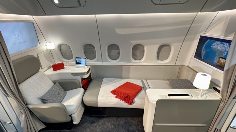 a bed and chair in a plane