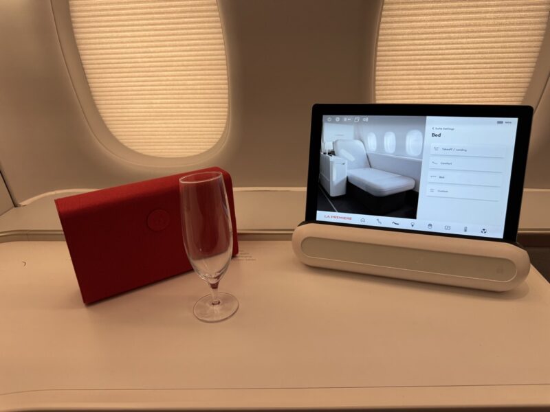 a computer screen and a wine glass on a table