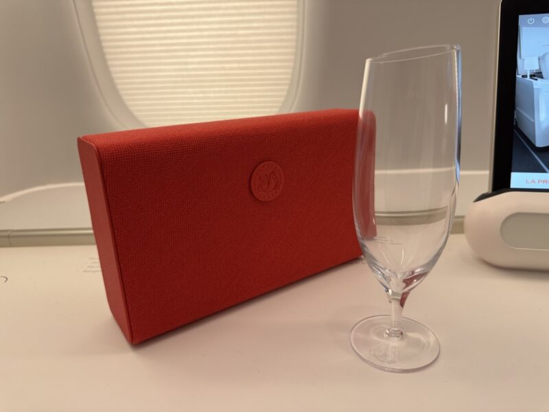 a wine glass next to a red box