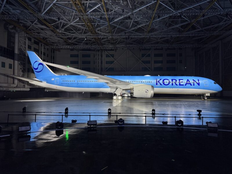 a blue and white airplane in a hangar