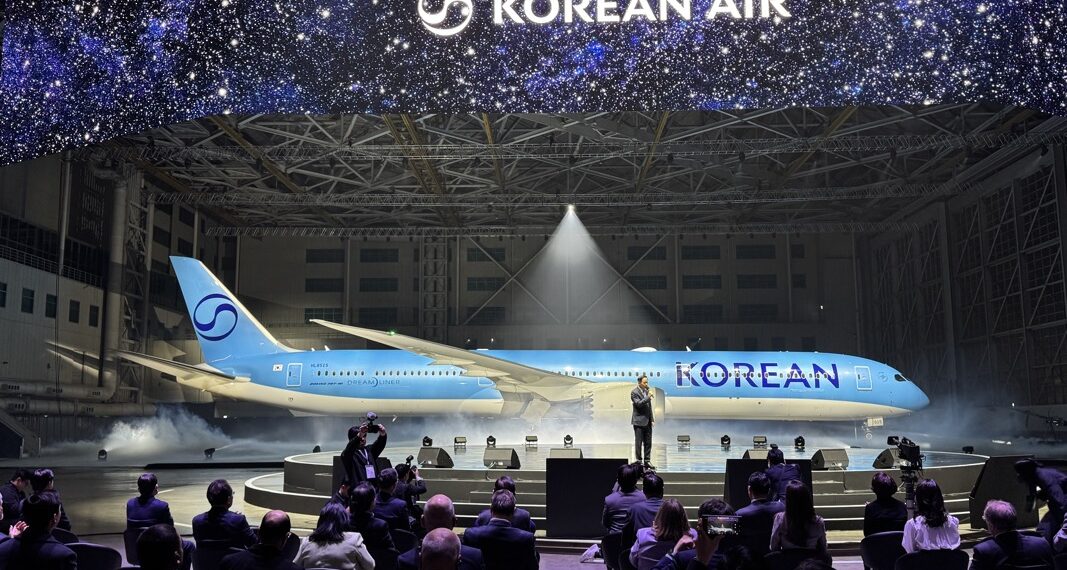 a group of people sitting in chairs in front of an airplane