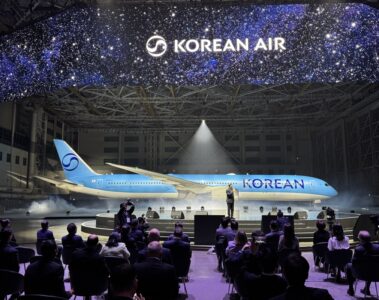 a group of people sitting in chairs in front of an airplane