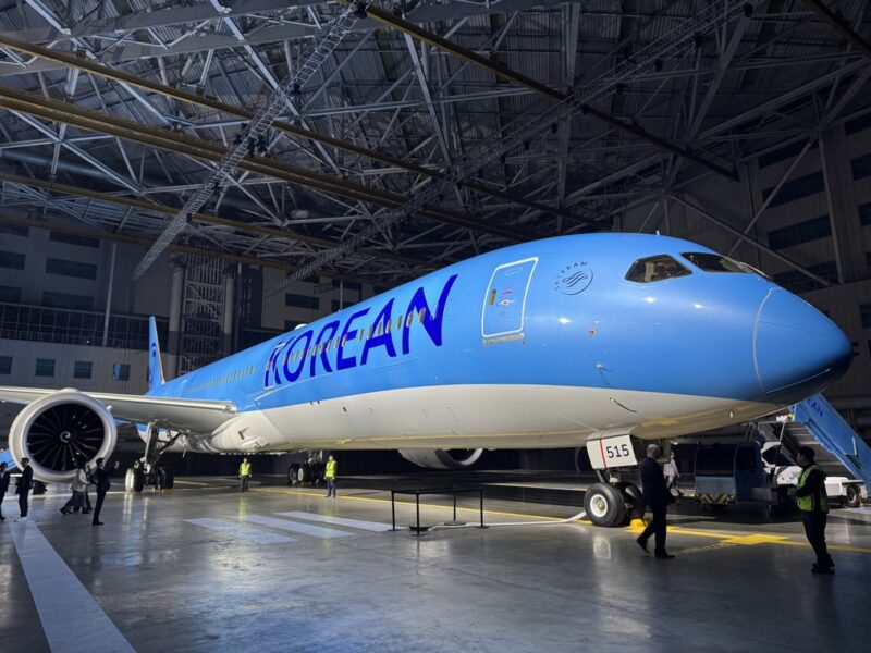 a blue and white airplane in a hangar