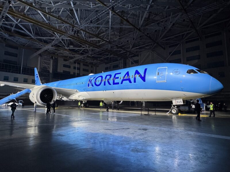 a blue and white airplane in a hangar