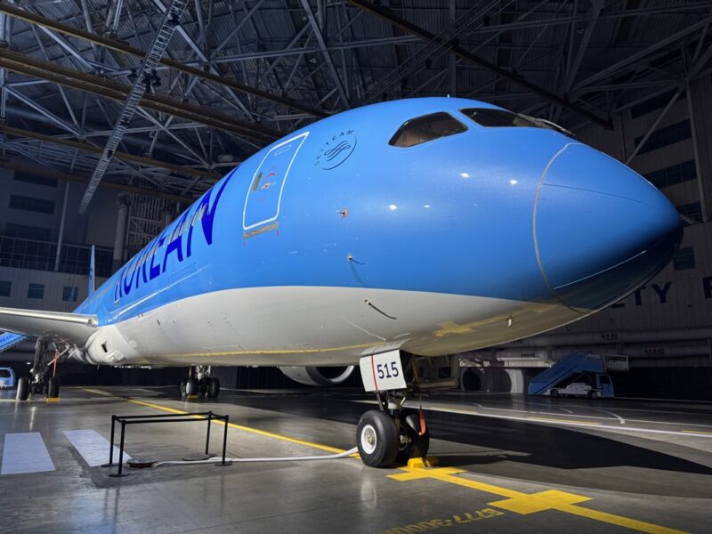 a blue and white airplane in a hangar