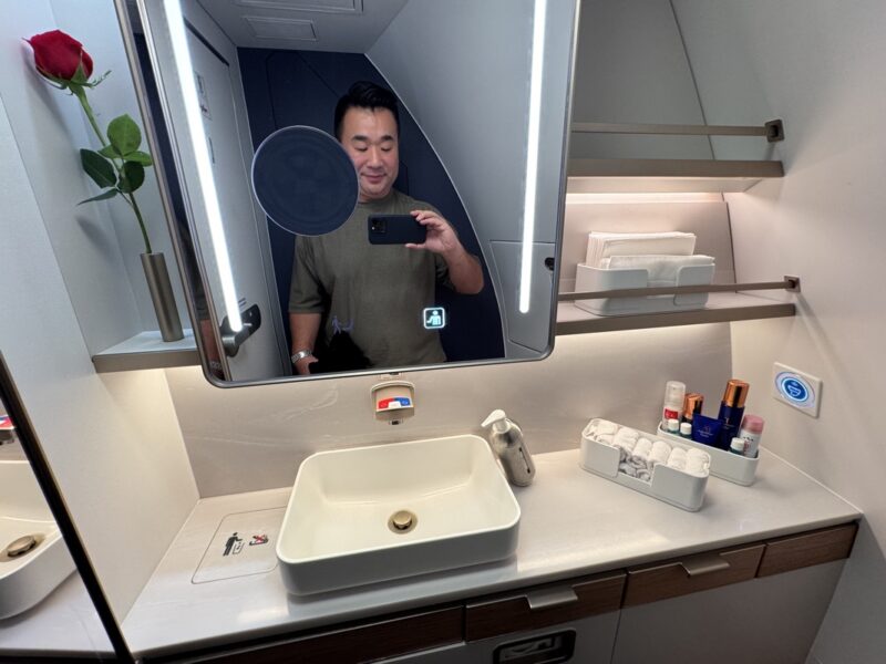 a man taking a selfie in a bathroom mirror