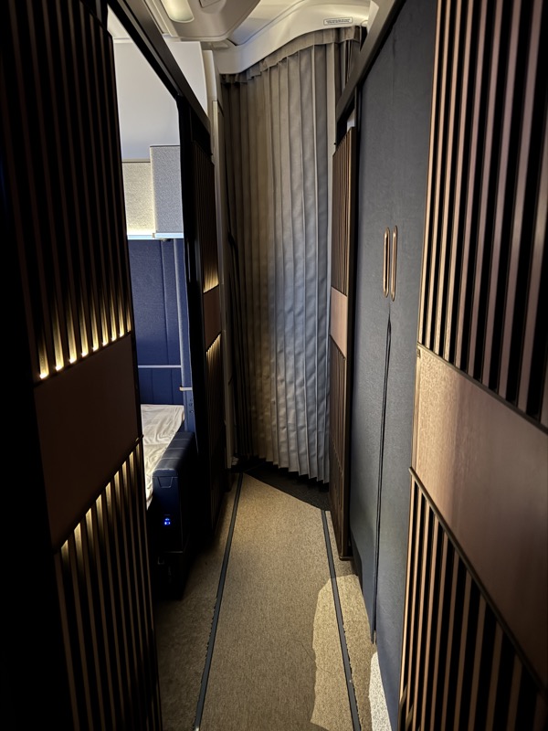 a hallway with a bed and a door