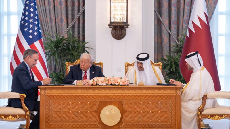 a group of people sitting at a desk