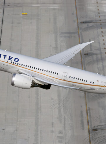 a plane flying over a runway