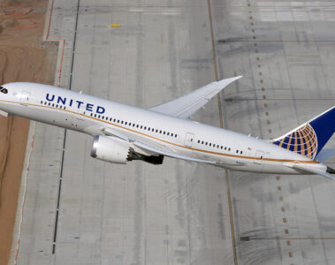 a plane flying over a runway